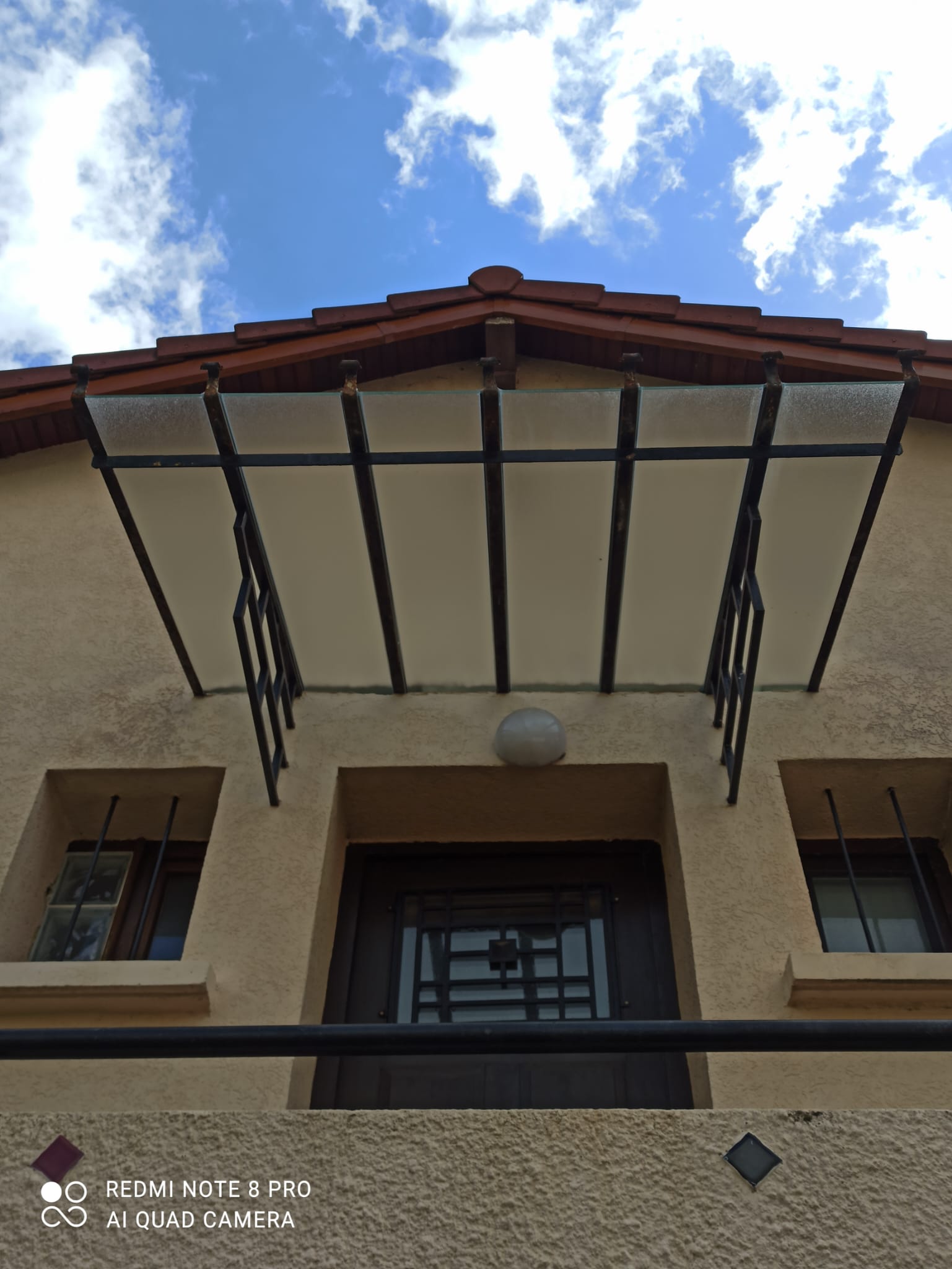 Marquise vitrée posée au-dessus d'une porte d'entrée à Bourgoin-Jallieu (38)